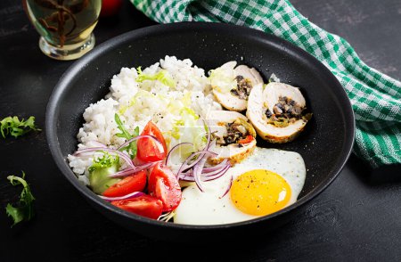 Photo for Fried egg, meat chicken roll, rice and tomatoes. Paleo breakfast. - Royalty Free Image