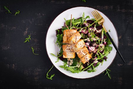 Photo for Baked tofu skewers in sauce and beet salad, arugula with vegetable yogurt sauce. Healthy vegan food concept. Healthy food. Top view, flat lay - Royalty Free Image
