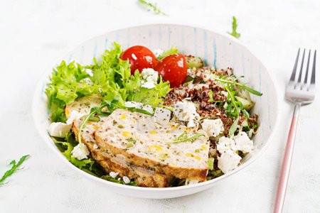 Photo for Healthy salad bowl with quinoa, tomatoes, chicken meatloaf and feta cheese on bowl. Food and health. - Royalty Free Image