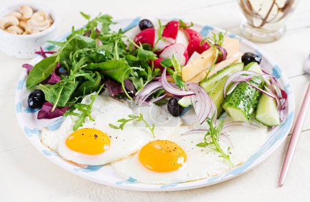 Photo for Ketogenic food. Fried egg, cheese, nuts and fresh salad. Keto, paleo breakfast. - Royalty Free Image