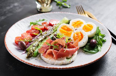 Photo for Keto breakfast. Fried asparagus with boiled eggs and toast with prosciutto or jamon. Ketogenic diet. Healthy food. - Royalty Free Image