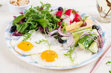 Photo for Ketogenic food. Fried egg, cheese, nuts and fresh salad. Keto, paleo breakfast. - Royalty Free Image