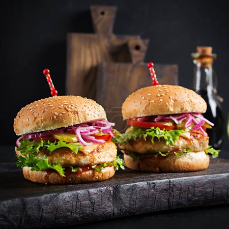 Photo for Chicken hamburger. Sandwich with chicken burger, tomatoes, cheese and lettuce. Cheeseburger. - Royalty Free Image