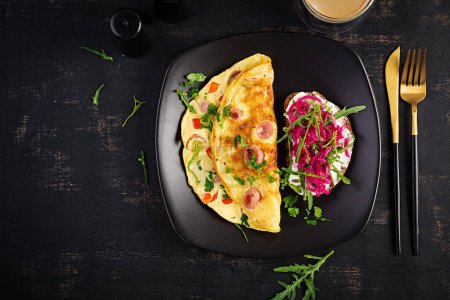 Photo for Breakfast. Omelette with sausage, sweet peppers and sandwich with marinated red onions. Frittata - italian omelet. Top view - Royalty Free Image