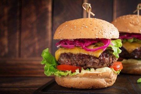 Photo for Beef hamburger. Sandwich with beef burger, tomatoes, cheese, pickled cucumber and lettuce. Cheeseburger. - Royalty Free Image