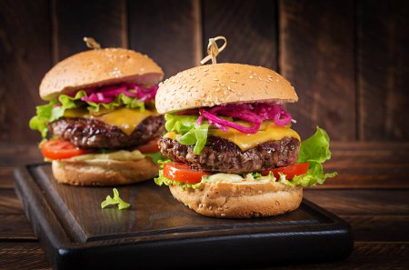 Photo for Beef hamburger. Sandwich with beef burger, tomatoes, cheese, pickled cucumber and lettuce. Cheeseburger. - Royalty Free Image