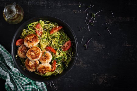 Photo for Zucchini spaghetti pasta  with chicken meatballs in pan. Top view. Flat lay - Royalty Free Image