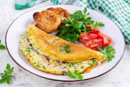 Photo for Omelette with tomatoes, cheese and red onion on white plate.  Frittata - italian omelet. - Royalty Free Image