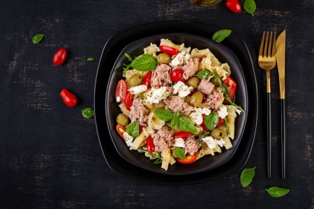 Photo for Pasta with tuna, tomatoes and feta cheese. Pasta salad with tuna. Healthy italian food. Healthy dinner. Top view, flat lay - Royalty Free Image