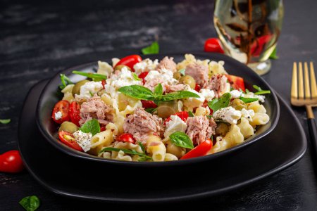 Photo for Pasta with tuna, tomatoes and feta cheese. Pasta salad with tuna. Healthy italian food. Healthy dinner. - Royalty Free Image