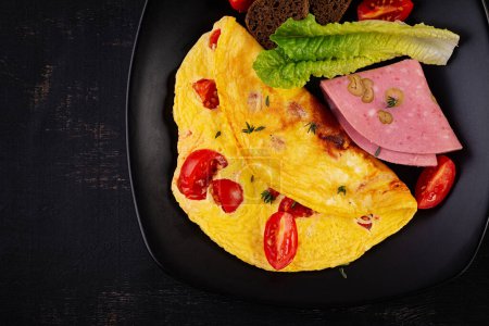 Photo for Omelette with tomatoes and cheese with bread and mortadella sausage. Top view - Royalty Free Image