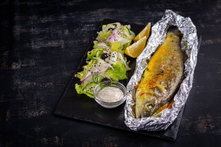Photo for Baked sea bass and green salad. Healthy eating. Keto, ketogenic diet. Top view - Royalty Free Image