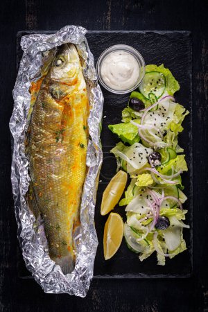 Photo for Baked sea bass and green salad. Healthy eating. Keto, ketogenic diet. Top view - Royalty Free Image