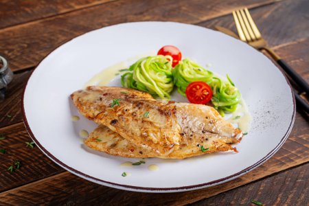 Photo for Grilled fish fillet with zucchini pasta. Healthy food concept. - Royalty Free Image