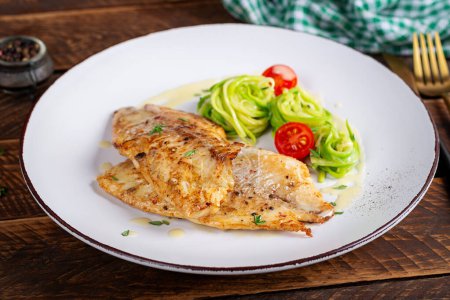 Photo for Grilled fish fillet with zucchini pasta. Healthy food concept. - Royalty Free Image