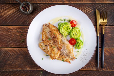 Photo for Grilled fish fillet with zucchini pasta. Healthy food concept. Top view, flat lay - Royalty Free Image