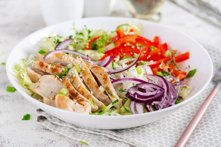 Photo for Fresh  salad  with grilled chicken breast, fillet and lettuce, daikon, red onions, cucumber and sesame. Healthy lunch menu. Diet food. - Royalty Free Image