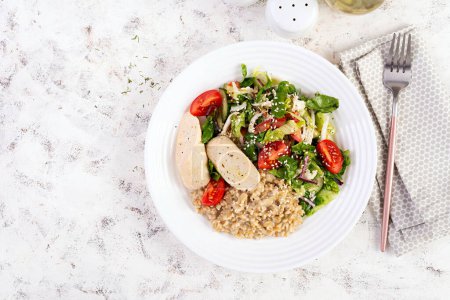 Photo for Breakfast oatmeal porridge with boiled homemade chicken sausage and fresh salad. Healthy balanced food. Trendy food. Top view, flat lay - Royalty Free Image