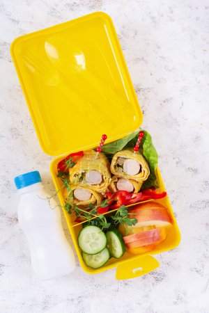 Photo for School lunch box with sausage roll in omelette with lavash. Lunchbox. Keto lunch. Top view, flat lay - Royalty Free Image