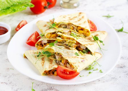 Photo for Mexican Quesadilla wrap with chicken, corn and sweet pepper on white plate. - Royalty Free Image