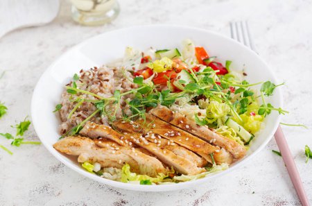 Photo for Lunch oatmeal porridge with grilled chicken fillet and fresh vegetables. Healthy balanced food. Trendy food. - Royalty Free Image