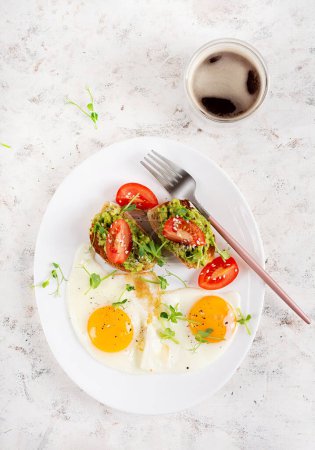 Photo for Keto breakfast. Fried eggs and toast with guacamole and tomatoes. Top view, flat lay - Royalty Free Image