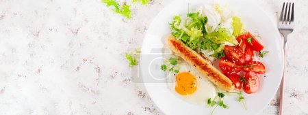 Photo for Keto breakfast. Fried egg and chicken sausage and fresh salad. Top view, banner - Royalty Free Image