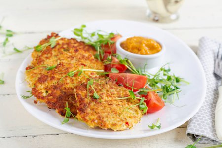 Photo for Potato fritters or pancakes served with sauce. European cuisine. Kosher eating. Vegan food. - Royalty Free Image