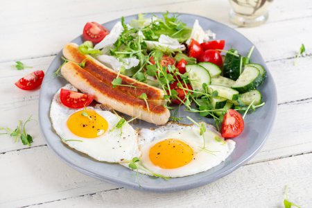Photo for Keto breakfast. Fried eggs and chicken sausage and fresh salad. - Royalty Free Image