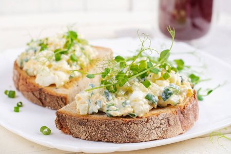 Photo for Delicious toast with pate boiled egg, cucumber and cream cheese on a white plate. Healthy eating, breakfast. Keto diet food. Tasty food. - Royalty Free Image