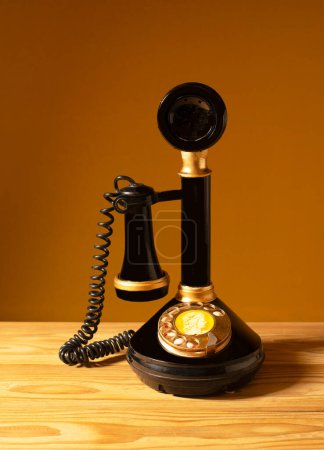 Photo for An old telephone as a decoration in the room on a wooden table - Royalty Free Image