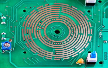 Photo for Changeover switch integrated in PCB copper layer, on-off button or resistor trimmer. Closeup of electronic components and range selector directly in green printed circuit board from multimeter inside. - Royalty Free Image