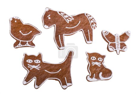 Photo for Baked gingerbread cookies in cat, horse or bird and butterfly shape isolated on a white background. Set of cute eatable animal toys decorated with sweet icing. Czech pastry for Christmas or child party. - Royalty Free Image