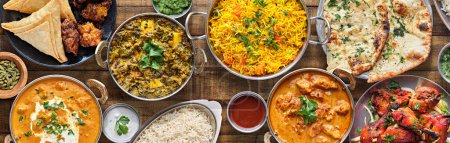 Foto de Indian food feast with chicken tikka masala curry, tandoori chicken and appetizers - Imagen libre de derechos