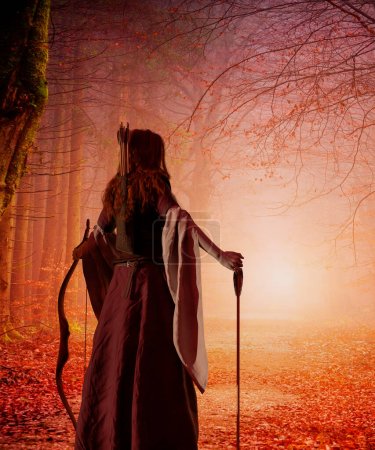 Téléchargez les photos : Une femme aux cheveux roux archer du Moyen Age avec un arc dans une forêt d'automne. Monde fantastique. Rendu 3d - en image libre de droit