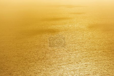 Photo for Surface water background of the ocean at sunset with a golden light tone. Pylos, Greece. - Royalty Free Image