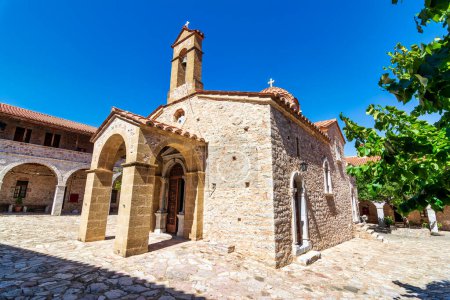 Photo for Voulkanos Monastery church on Ithomi mountain against a clear sunny sky. The Holy Dormition Monastery of Theotokos Vulkanou is Messinia's most historic and largest Monastery. - Royalty Free Image