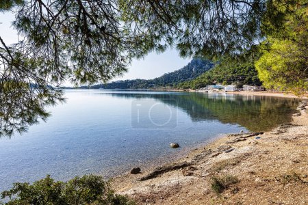 Photo for Experience the breathtaking beauty of Greece on a sunny day by visiting the stunning Vouliagmeni Lake near Loutraki. - Royalty Free Image