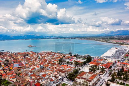 View from Palamidi on Nafplio city in Greece with port, Bourtzi fortress, and blue Mediterranean sea. Cloudy day.