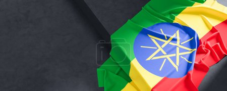 Flag of Ethiopia. Fabric textured Ethiopia flag isolated on dark background. 3D illustration