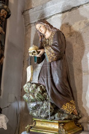 Photo for A Ponte Ulla, Spain. Wooden sculpture representing Saint Mary Magdalene holding a human skull - Royalty Free Image