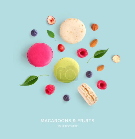 Photo for Creative layout made of macaroons, raspberry, blueberry and nuts . Flat lay. Food concept. Abstract background. - Royalty Free Image
