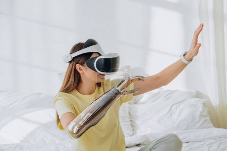 A woman explores virtual reality, wearing a VR headset and interacting with a futuristic robotic arm in a bright bedroom, symbolizing the blend of virtual experiences with advanced technology. Woman