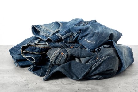 Photo for Heap of fashion denim jeans over white background. - Royalty Free Image