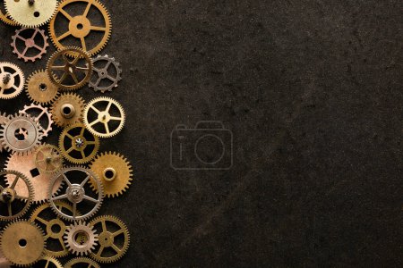 Photo for Mechanical watch repairing concept. cogwheels on the left of metal desk. - Royalty Free Image