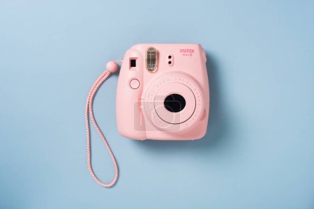 Photo for BANGKOK, THAILAND - OCTOBER 09, 2019: The pink Fujifilm Instax mini 8 instant camera on blue background. - Royalty Free Image
