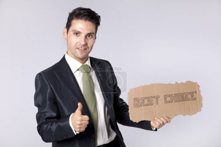 young businessman holding a piece of cardboard saying that he is the best choice