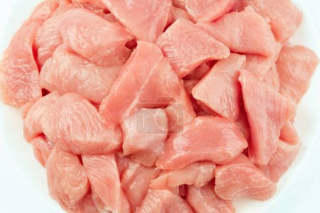 Fresh frozen pieces of turkey meat on a white background.Raw chicken.Frozen chicken fillet..Ogranic food and healthy eating.frozen turkey or poultry meat.Chicken Skewers breast fillet meat