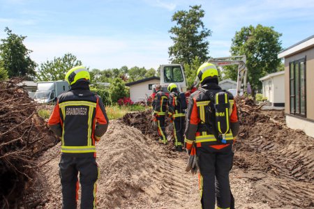 Photo for Firefighters must take action if a gas pipe is hit during excavation work at Park de IJsselhoeve in Nieuwerkerk aan den IJssel the Netherlands - Royalty Free Image
