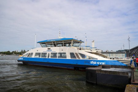 Photo for City ferry in Amsterdam over the IJ Water. These ferries runned bij GVB and are for pedestrians and cyclist. Access is free of charge - Royalty Free Image
